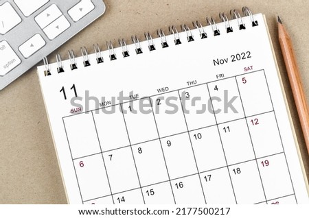 November 2022 desk calendar with pencil on wooden background. Photo stock © 