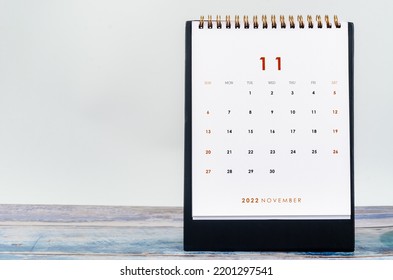 November 2022 Monthly Desk Calendar For 2022 Year On Old Blue Wooden Background