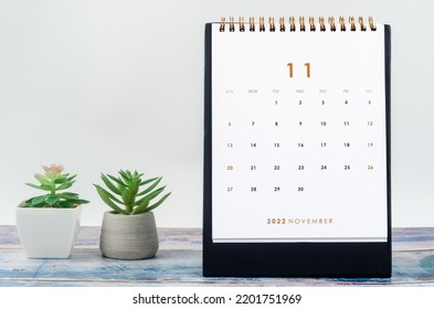 November 2022 Monthly Desk Calendar For 2022 Year On Old Blue Wooden Background