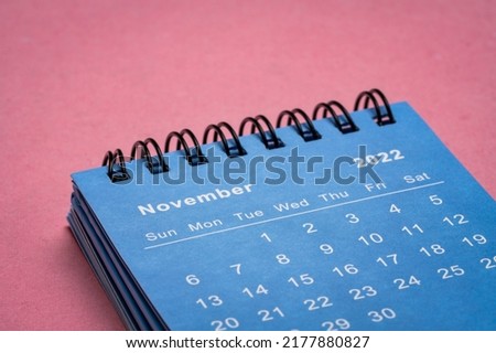 November 2022 - small spiral desktop calendar against textured  paper, low angle macro shot, time and business concept Сток-фото © 