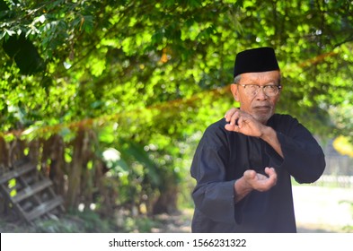 November 21, 2019 - Sabak Bernam, Malaysia. A Local Old Malay Man With His Traditional Martial Art Dress And Pose With The Village Green Background In Malaysia.