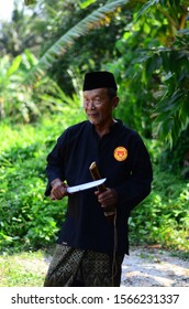 November 21, 2019 - Sabak Bernam, Malaysia. A Local Old Malay Man With His Traditional Martial Art Dress And Pose With The Village Green Background In Malaysia.