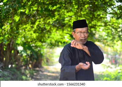 November 21, 2019 - Sabak Bernam, Malaysia. A Local Old Malay Man With His Traditional Martial Art Dress And Pose With The Village Green Background In Malaysia.