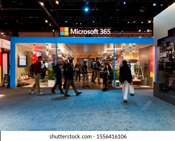 November 6, 2019 Microsoft Ignite attendee walks passed by Microsoft 365 booth. 
