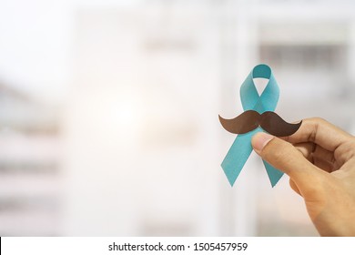 November Prostate Cancer Awareness month, Man holding Blue Ribbon with mustache  for supporting people living and illness. Healthcare, International men, Father and World cancer day concept - Shutterstock ID 1505457959