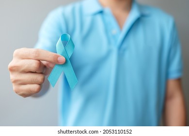 November Prostate Cancer Awareness month, Man in blue shirt with hand holding Blue Ribbon for supporting people living and illness. Healthcare, International men, Father and World cancer day concept - Shutterstock ID 2053110152