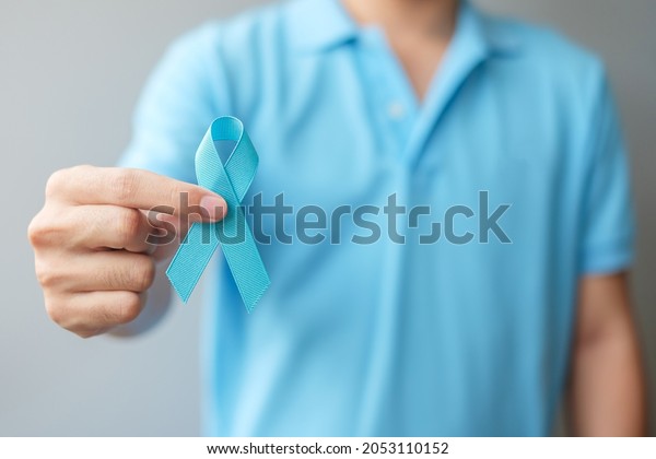 November Prostate Cancer Awareness month, Man in\
blue shirt with hand holding Blue Ribbon for supporting people\
living and illness. Healthcare, International men, Father and World\
cancer day concept