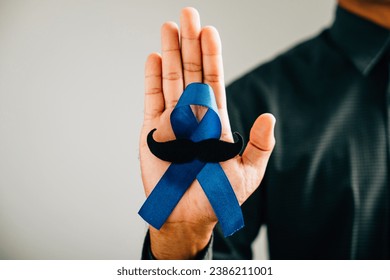 In November, support Prostate Cancer Awareness with a Blue Ribbon and mustache a symbol of care, unity, and men's health. Ideal for healthcare, awareness, and family-oriented events. - Powered by Shutterstock