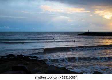 In November, Unidentified People Went For A Swim At Sunset At Sidmouth Beach, English Channel, England