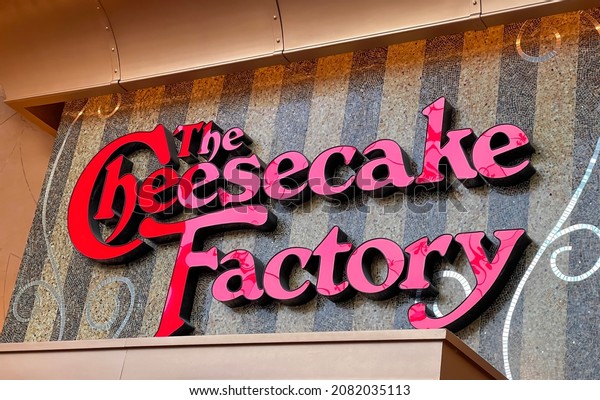 Novi, MI - August 8, 2021: The Cheesecake Factory\
restaurant building exterior signs outside the Twelve Oaks Mall in\
Novi, MI.