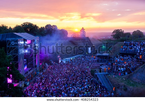 NOVI SAD - JULY 12 : Crowd in front of\
the Dance Arena on sunrise at EXIT 2015 Music Festival July 12,\
2015 in Novi Sad, Petrovaradin Fortress, Serbia\
