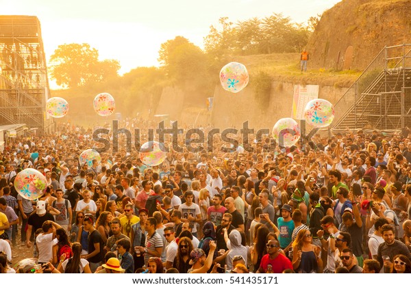 NOVI SAD - JULY 12 : Crowd in the\
sunrise on Dj Arena dance stage at EXIT 2015 Music Festival July\
12, 2015 in Novi Sad, Petrovaradin Fortress,\
Serbia