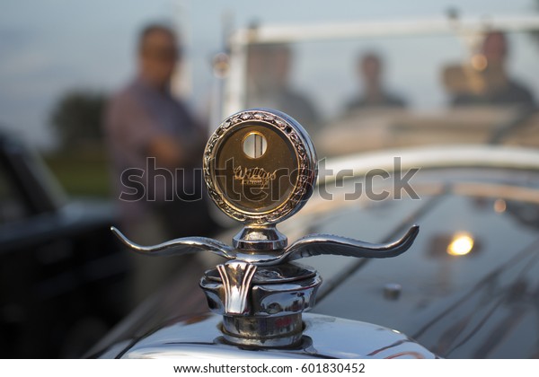 NOVI SAD, SERBIA - AUGUST 30 2014:\
EXHIBITION OF OLDTIMERS, XX INTERNATIONAL MEETING OF OLD FASHIONED\
VEHICLES. PEOPLE WATCH OLD CARS. vINTAGE\
EMBLEM.