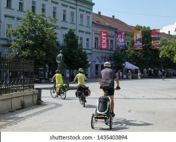 Novi Sad, Serbia, June 25th 2019. - Three People Tourists  Are Enjoying Their Vacation, Riding Their Bikes Down A Main Street In Novi Sad, Preparing For EXIT Music Festival