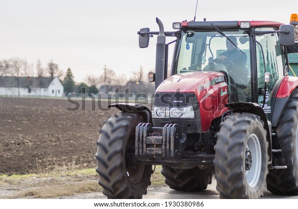 Novi Sad,\
Serbia - March 05. 2021: Agricultural tractor in public transport\
on the highway. Novi Sad,\
Serbia.
