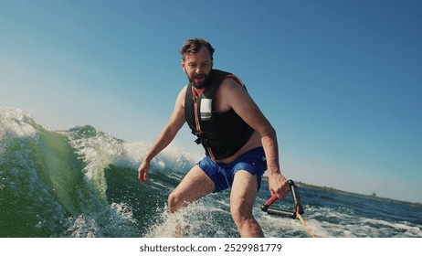 A novice athlete falls from a wakeboard while riding at high speed. Water sprays up, showing a moment of loss of balance and adrenaline. The scene reflects the risk and dynamics of water extreme sport - Powered by Shutterstock