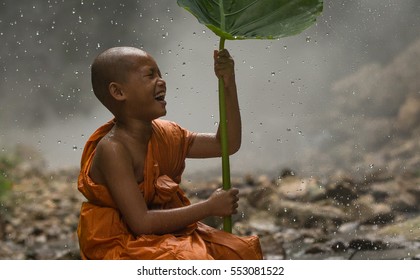Novice Monk  thailand playing in the nature around of them, monk stay outdoors Waterfall background in Thailand nature around of them - Powered by Shutterstock