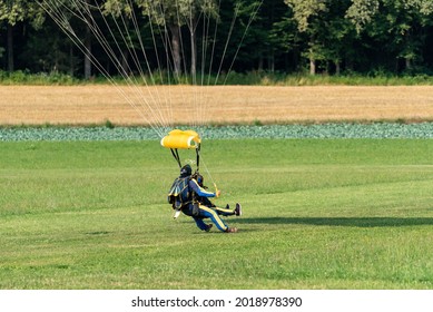 Novo Mesto, Slovenia, July 23, 2021: Skydiving. Parachutes during flight and landing with an unfolded parachute, view from the ground.