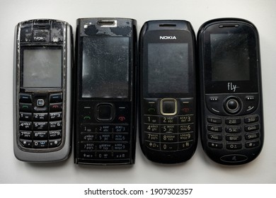Novosibirsk, Novosibirsk region, Russian Federation, 24.06.2020. Old used Nokia and fly cell phones, close-up on a white background
