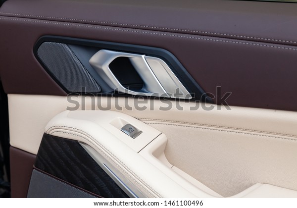 Novosibirsk, Russia -\
07.20.2019: View to the white and brown interior of BMW X7 M\
Performance with dashboard, door handle and control buttons after\
cleaning before sale on\
parking
