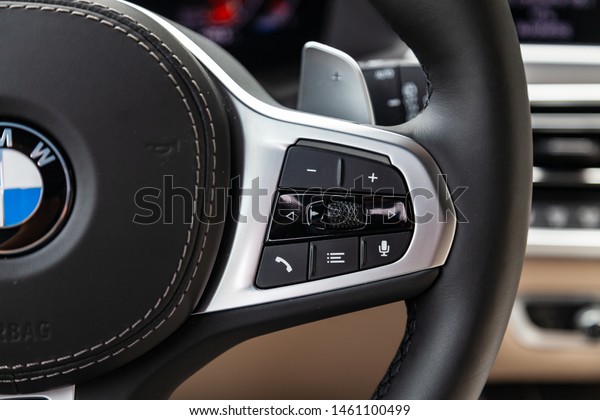 Novosibirsk, Russia - 07.20.2019:\
View to the white and brown interior of BMW X7 M Performance with\
dashboard, steering wheel, phone multifunction buttons and\
shiftgear