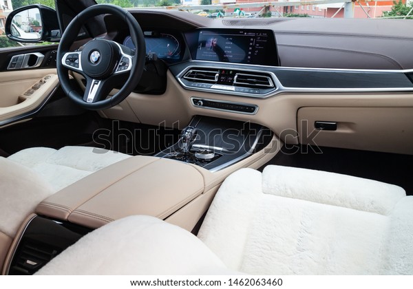 Novosibirsk, Russia -\
07.20.2019: View to the white and brown interior of BMW X7 M\
Performance with dashboard, media system, display, front seats,\
steering and shiftgear  on\
parking
