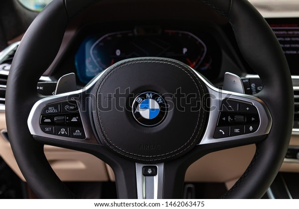 Novosibirsk, Russia\
- 07.20.2019: View to the white and brown interior of BMW X7 M\
Performance with dashboard, steering wheel, display, cockpit after\
cleaning before sale on\
parking