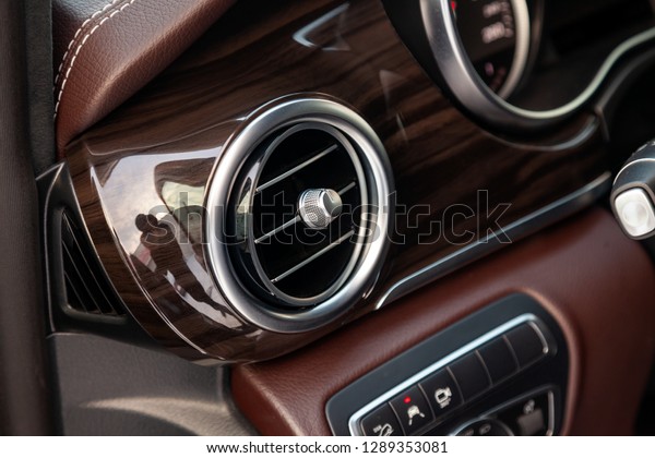 Novosibirsk, Russia - 08.01.2018: The interior\
elements of a new expensive business Mercedes V-class car inside\
with deflector and the leather, the central control panel with wood\
and chrome
