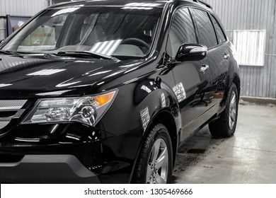Novosibirsk, Russia - 08.01.2018: Used Acura MDX 2008 year black color with headlights standing in the light service box of the detailing workshop after polish and washing - Shutterstock ID 1305469666