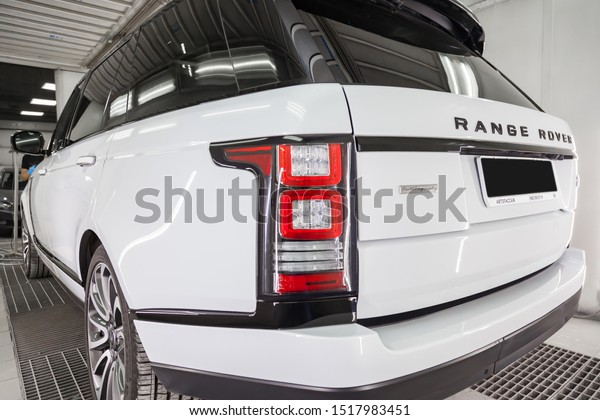 Novosibirsk, Russia - 08.01.2018: White and\
black Land Rover Range Rover Autobiography rear view in auto\
service garage waiting for wash and\
detailing.