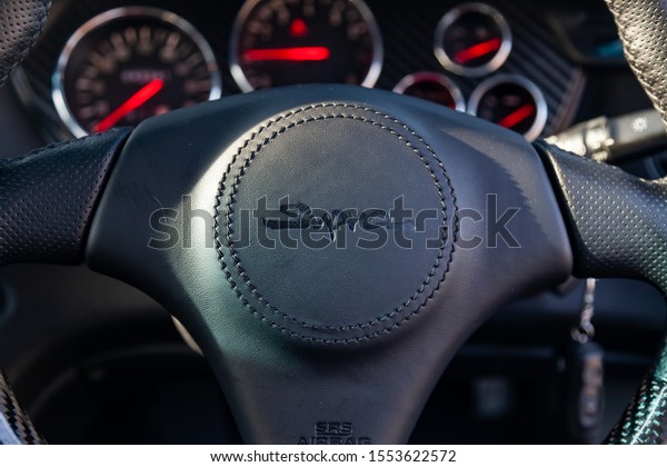 Novosibirsk, Russia -\
10.09.2019: Interior of a rare Japanese sports car in the back of a\
gray Toyota Supra coupe with a dashboard, steering wheel, panel\
cockpit and carbon\
trim