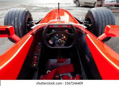 Novosibirsk, Russia - 11.01.2019: Cockpit and steering wheel view of red Ferrari racing sports cars for Formula 1 on the street near the garage box.