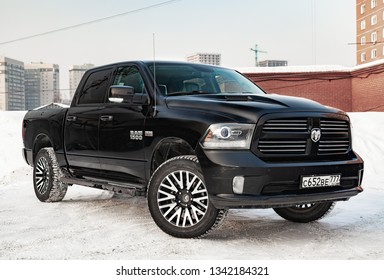 Novosibirsk, Russia - 12.01.2018: Black Dodge Ram with an engine of 5.7 liters front view on the car parking with snow background.