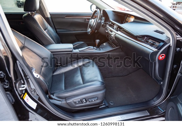 Novosibirsk, Russia - 12.06.2018: Interior inside\
the car: front passenger seat, overwhelmed with genuine black\
leather, modern interior design with wood elements, luxurious\
central control\
panel.