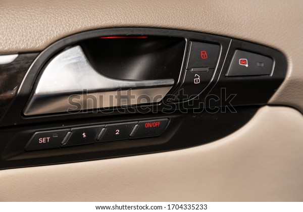 Novosibirsk/ Russia – April 02,\
2020: Audi Q7, closeup of a door control panel in a new car. Arm\
rest with window control panel, door lock button, and mirror\
control.\
