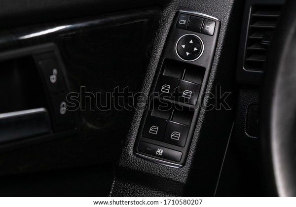 Novosibirsk/ Russia – April 04 2020:\
Mercedes-Benz GLK-class, Close up of a door control panel in a new\
modern car. Arm rest with window control panel, door lock button,\
and mirror\
control.\
