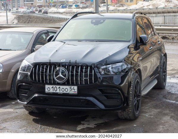 Novosibirsk, Russia - April 05 2021: private all-wheel\
drive black style color sport fast crossover Mercedes-Benz\
Mercedes-AMG GLE 63 S 4Matic V167 car made in Germany parking on\
urban city street 