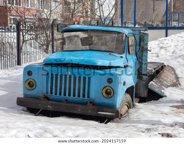 Novosibirsk, Russia, April 05 2021: private classic blue\
color small abandoned russian dump flatbed platform truck GAZ 52\
chassis old classic car made in soviet union USSR on winter snow\
urban street 