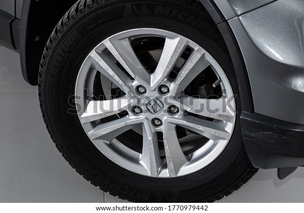 Novosibirsk/ Russia – April  11 2020: Honda CR-V, \
Car wheel with alloy wheel and new rubber on a car closeup. Wheel\
tuning disc\
