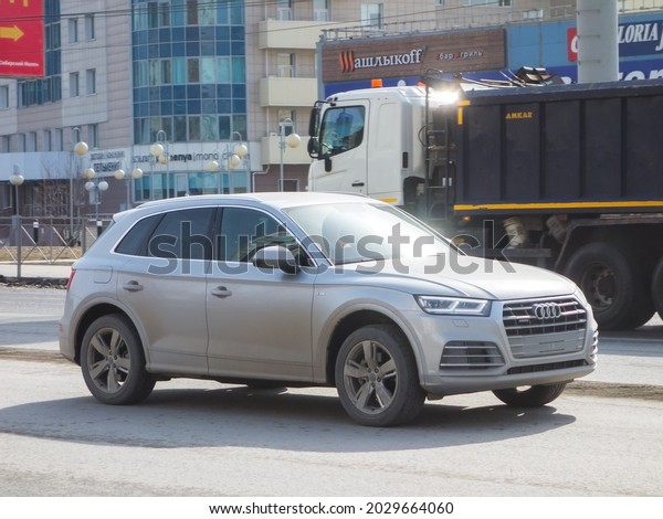 Novosibirsk, Russia - april 12 2021: private\
all-wheel drive silver gray metallic color new car compact midsize\
family crossover new Audi Q5, luxury 4wd SUV made in Germany drive\
on urban city\
street