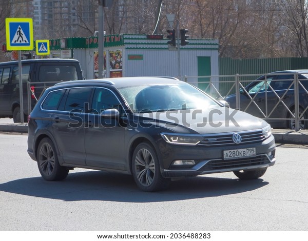 Novosibirsk, Russia - april 16 2021: private\
all-wheel drive black metallic color germany new crossover 4 wd\
Volkswagen Passat Variant Alltrack, midsize car made in Germany\
drive on sunny road\
street