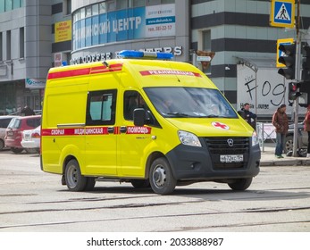 Novosibirsk, Russia - April 17 2021: Cargo Passenger Red Yellow Russian New Ambulance Mini Van Bus Car Based On Chassis GAZ Gazelle Next, Arriving On Emergency Call Fast Drive On Urban Broad Street