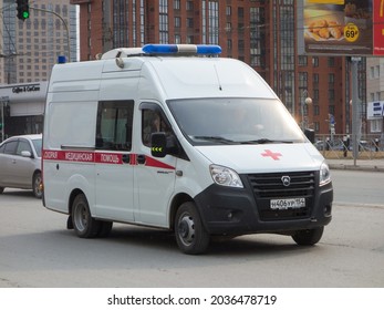 Novosibirsk, Russia, April 20 2021: Cargo Passenger Red White Russian New Ambulance Mini Van Bus Car Based On Chassis GAZ Gazelle Next  Arriving On Emergency Call Fast Drive On Urban Broad Street