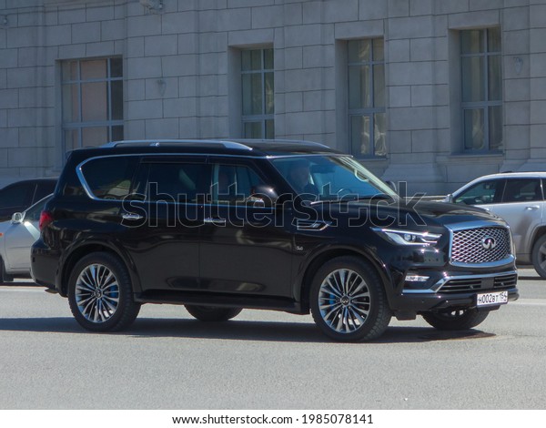 Novosibirsk, Russia - april 20 2021: private awd\
all-wheel 4wd 4x4 drive black metallic color japanese big frame\
crossover new Infiniti QX80 facelift luxury car SUV 4wd driving\
city urban broad\
street