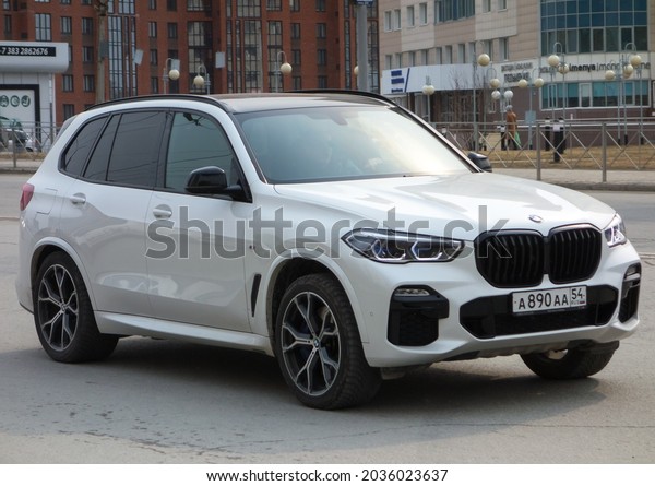 Novosibirsk, Russia - april 20 2021: private awd\
all-wheel drive white metallic color germany sport crossover new\
BMW X5 G05 xDrive30d, luxury car SUV 4wd with cool license plate\
drive on city\
street
