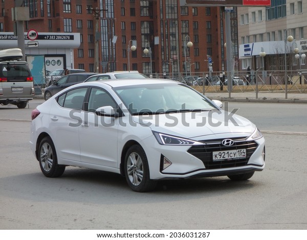 Novosibirsk, Russia - april 20 2021: private fwd\
compact white metallic color new cheap economy sedan South Korean\
car Hyundai Elantra 2016 facelift 2018, popular bestseller drive on\
city urban street