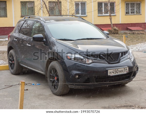Novosibirsk, Russia - april 21 2021: private awd\
all-wheel 4wd 4x4 drive black metallic color japanese sport coupe\
crossover old Nissan Murano II car SUV 4wd parking city urban\
spring street in\
yard