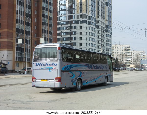 Novosibirsk, Russia, april 26 2021: blue metallic\
color big long germany old classic touristic charter tour bus Setra\
S 315 HD 300-Series, private transfer service vehicle driving on\
city urban street