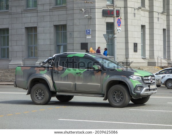 Novosibirsk, Russia - April 26 2021: private all-wheel\
drive khaki camouflage matt color pick-up truck crossover\
Mercedes-Benz X-Class X250d 4Matic Br. 470 car made in Germany on\
urban city street 