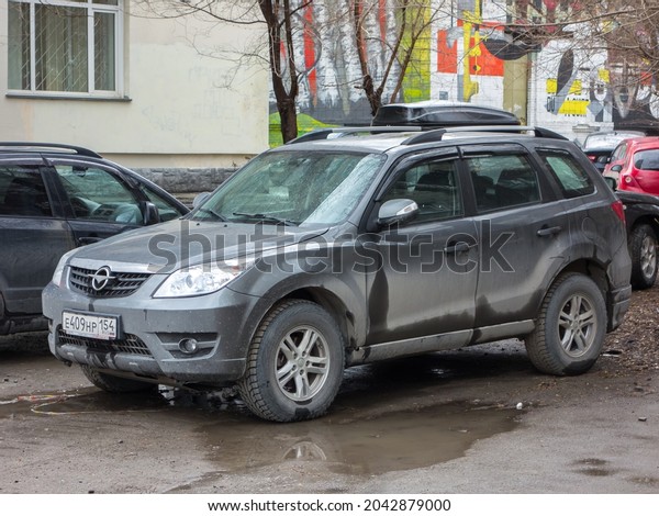 Novosibirsk, Russia, april 28 2021: private awd\
all-wheel drive gray color old chinese compact cheap crossover\
Haima 7 (clone fake Mazda Tribute) midsize 4wd SUV car made in\
China on urban city\
street